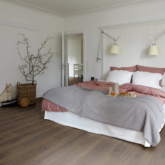 smoked mil oak plank laminate flooring displayed in a bedroom