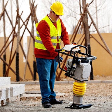 Załaduj obraz do przeglądarki galerii, yellow tamping rammer being used on a construction site
