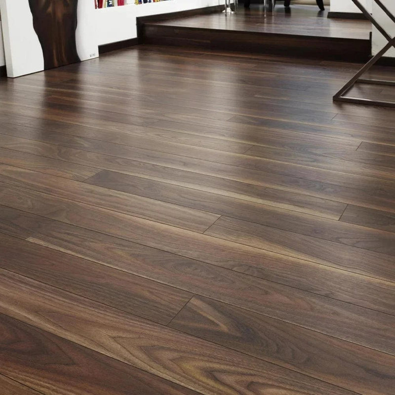 Załaduj obraz do przeglądarki galerii, dark walnut laminate flooring on display in a home setting
