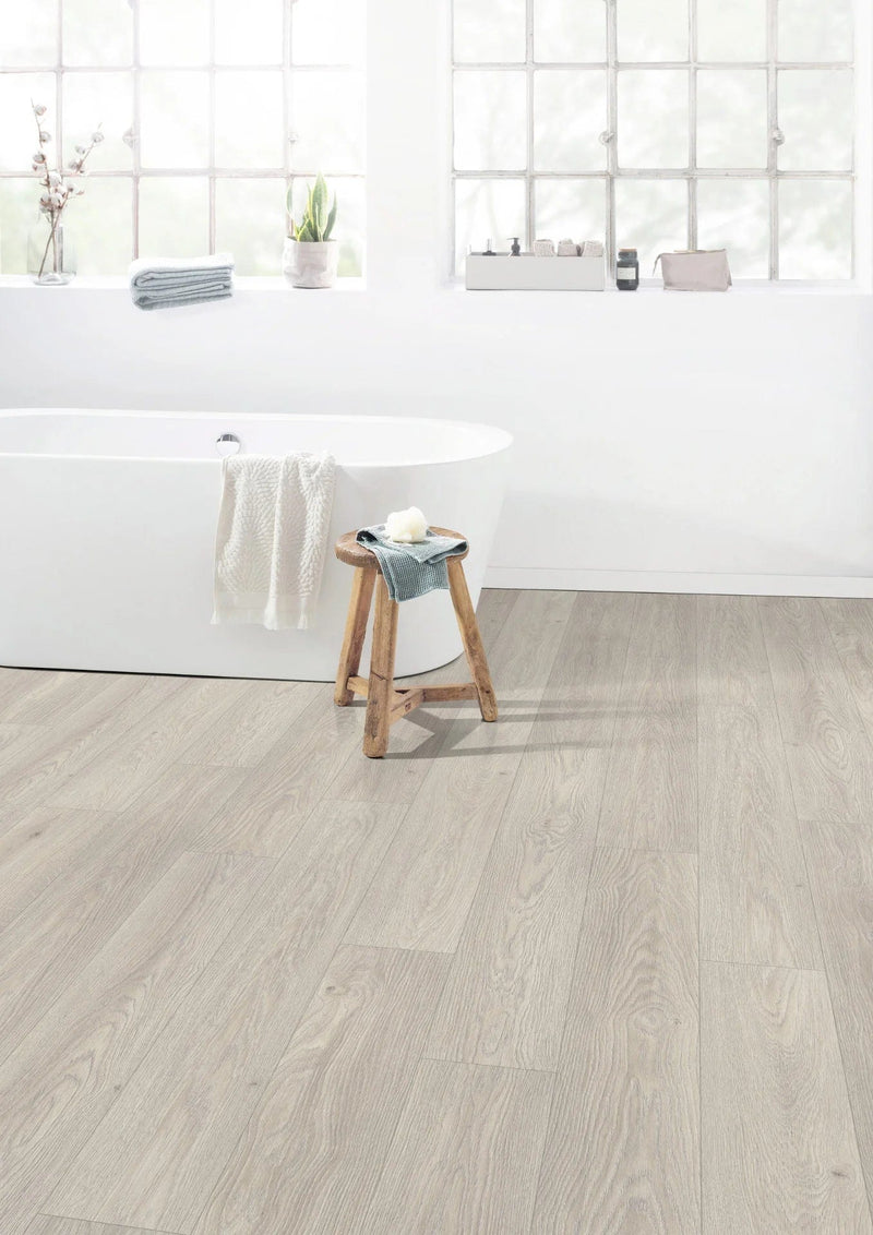 Load image into Gallery viewer, cesena oak white aqua laminate flooring on display in a bathroom
