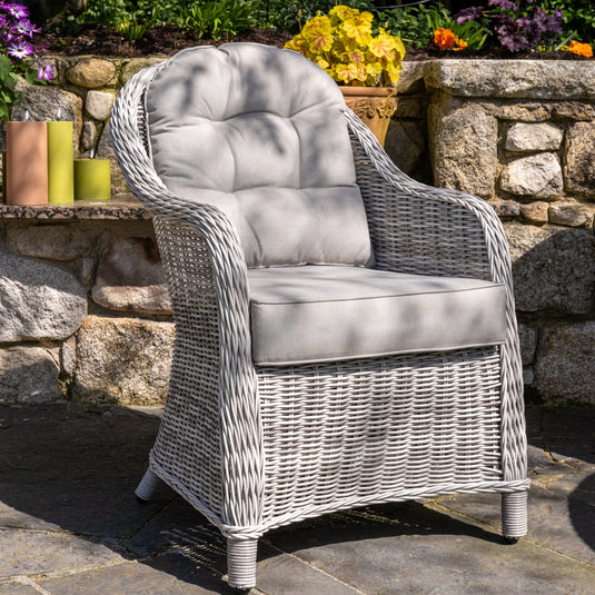 light grey curved armchair with light grey back and base cushions