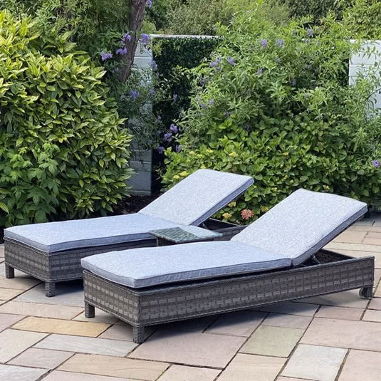 dark grey lounger with grey cushions and a small glass topped square side table. NOTE: only one lounger comes with one side table