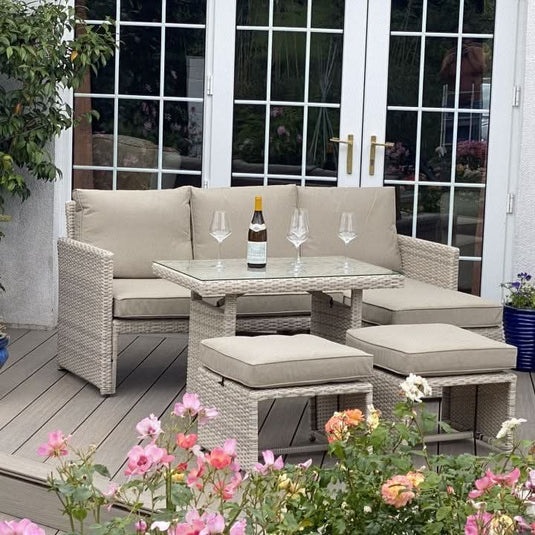 cream corner sofa set with glass topped rectangular table and 2 footstools