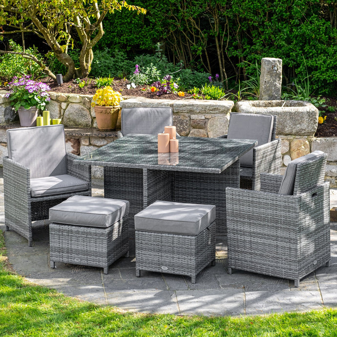 light grey 4 seater cube garden furniture set with 4 stools and a glass topped square table