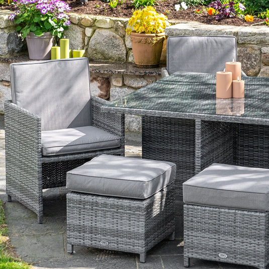 light grey 4 seater cube garden furniture set with 4 stools and a glass topped square table