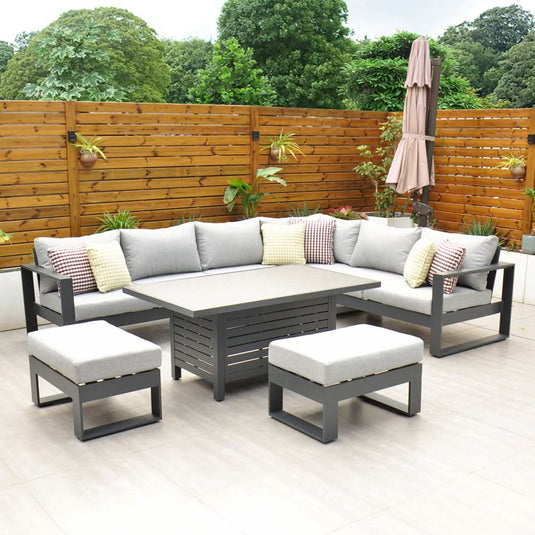 dark grey corner sofa set with a rectangular table and 2 stools and grey cushions