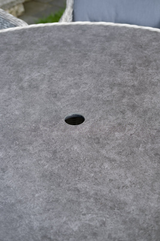 hole for parasol centrally situated within the round table