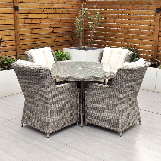 grey 4 seat set with 120cm glass topped round table and cream cushions