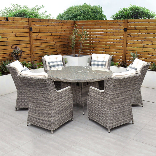 grey 6 seat set with 135cm glass topped round table and cream cushions