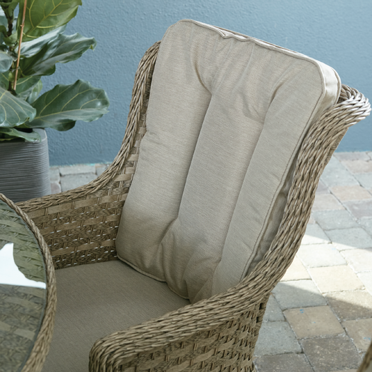 armchair in a natural colour with sand colour back and base cushions