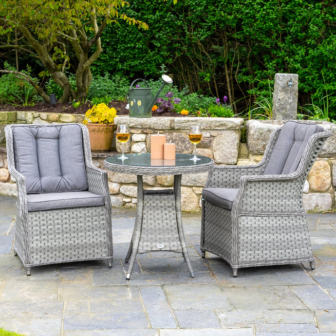 grey rattan bistro set with glass topped round table and 2 armchairs with cushions