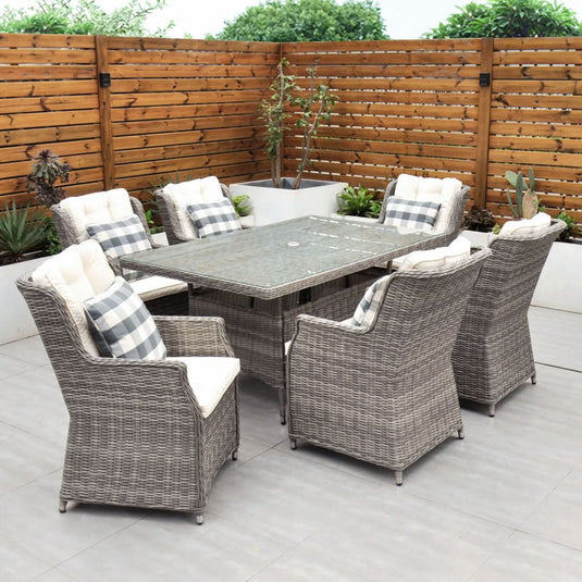 grey 6 seat set with cream cushions and a glass topped rectangular table with a hole for a parasol centrally situated within the table