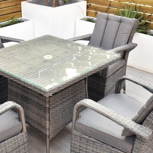 grey 4 seater set with glass topped square table and hole for parasol within table