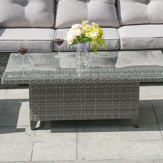 grey rectangular rising table with glass top